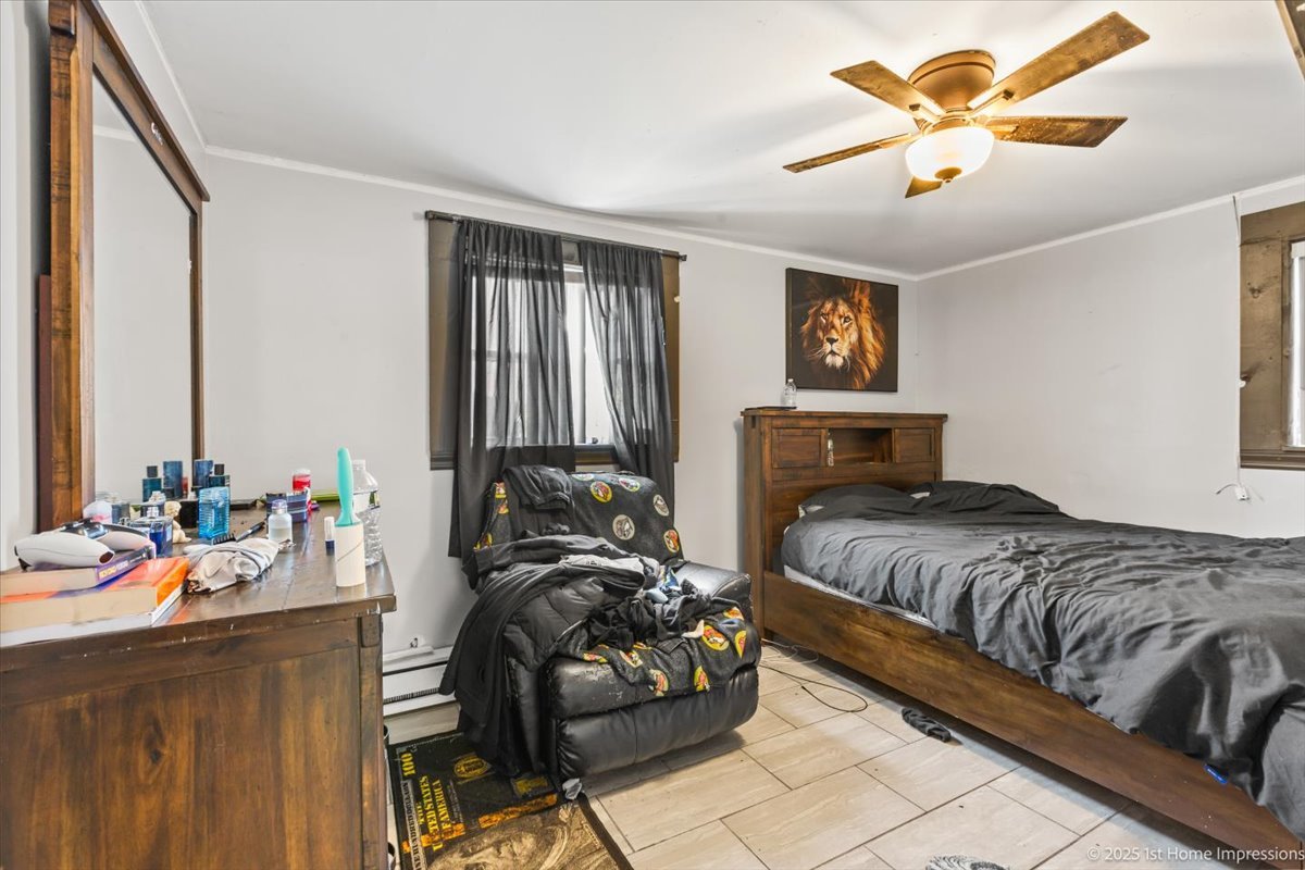 7110 West 107th Street, Unit 16 Worth, IL 60482 - Photo 6 of 12 a bedroom with a bed and a chandelier