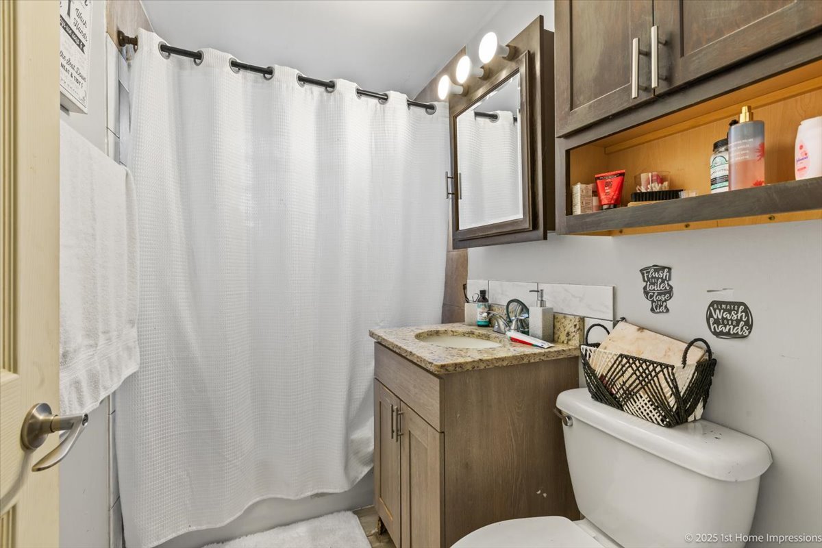 7110 West 107th Street, Unit 16 Worth, IL 60482 - Photo 7 of 12 a bathroom with a sink toilet and shower