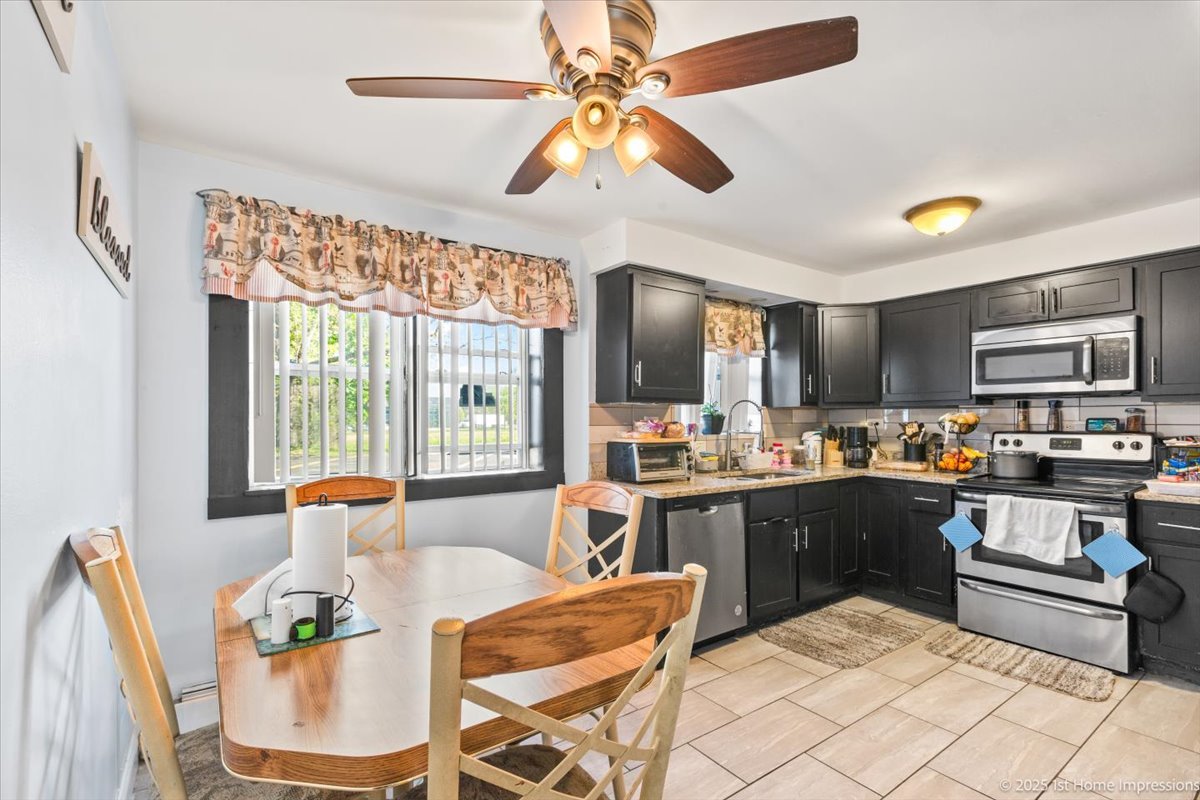 7110 West 107th Street, Unit 16 Worth, IL 60482 - Photo 8 of 12 a kitchen with stainless steel appliances granite countertop a stove and cabinets