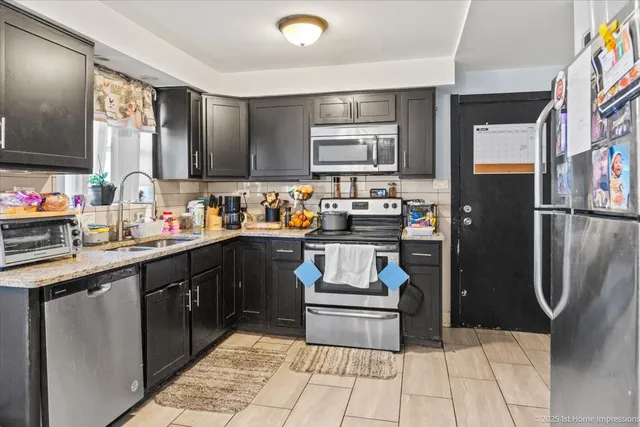 a kitchen with a sink appliances and cabinets