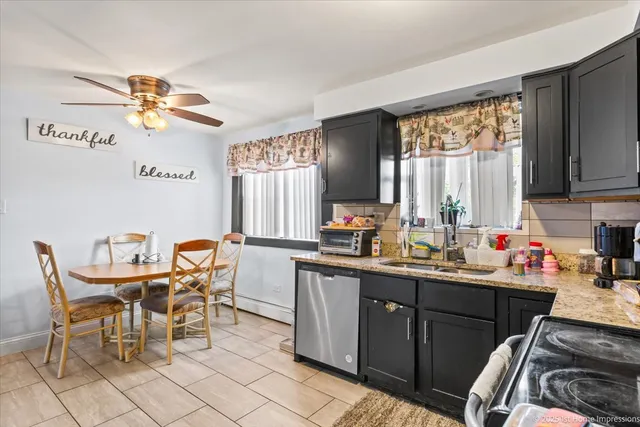 a kitchen with a dining table chairs and a refrigerator