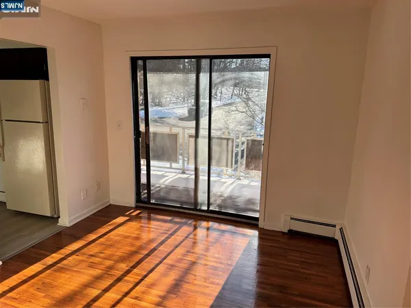 a view of a room with wooden floor and a sink