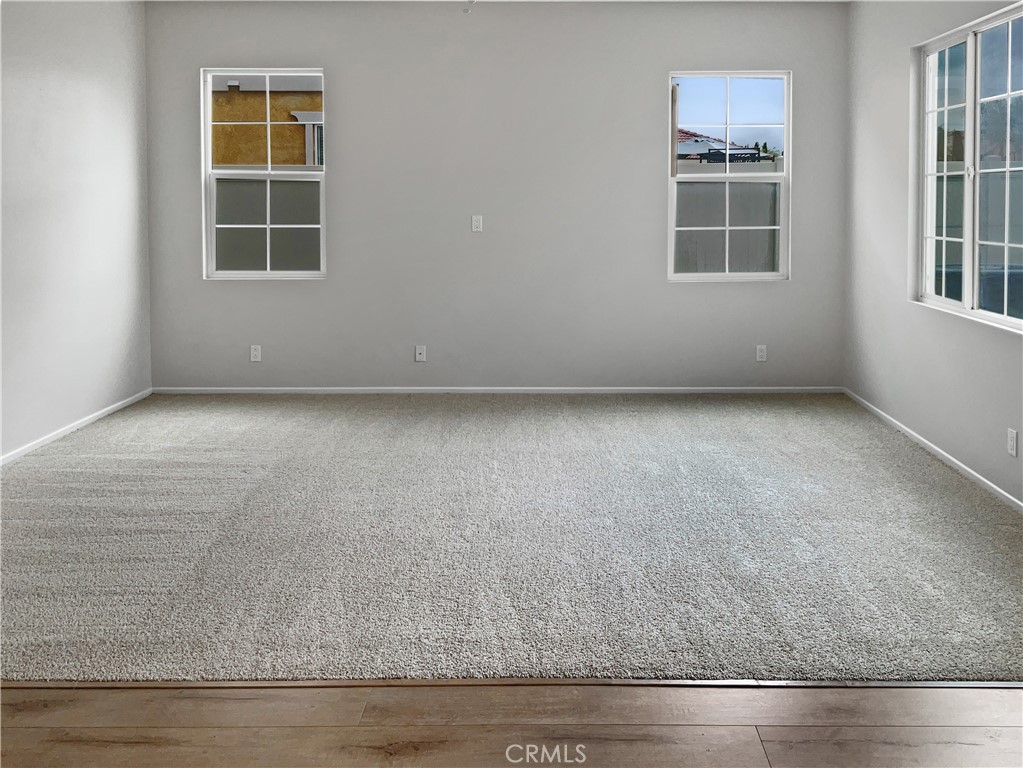 1966 Echo Road San Jacinto, CA 92582 - Photo 10 of 23 an empty room with wooden floor and windows