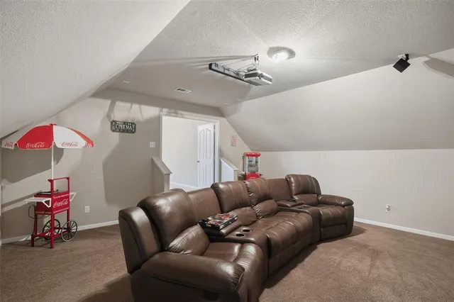 a living room with furniture and stairs