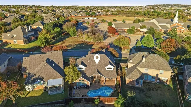 an aerial view of a house with a backyard