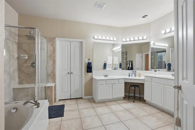 a large bathroom with a sink a mirror and a shower