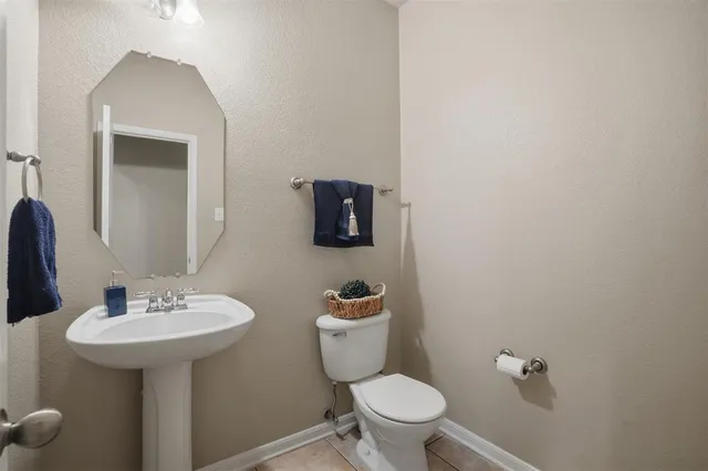 a bathroom with a sink a toilet and mirror