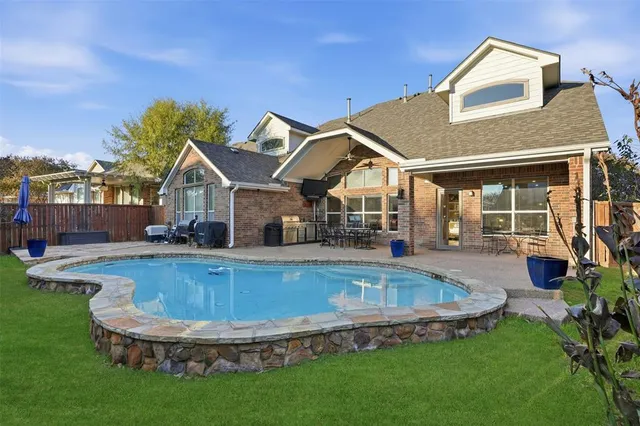 a view of a house with swimming pool and porch