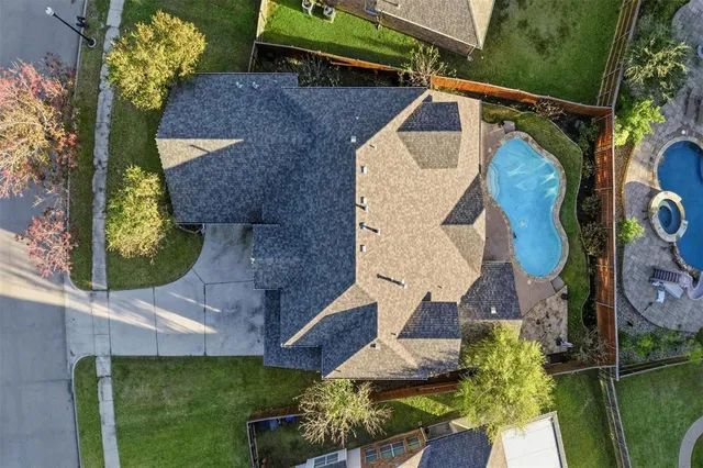 an aerial view of a house with a yard