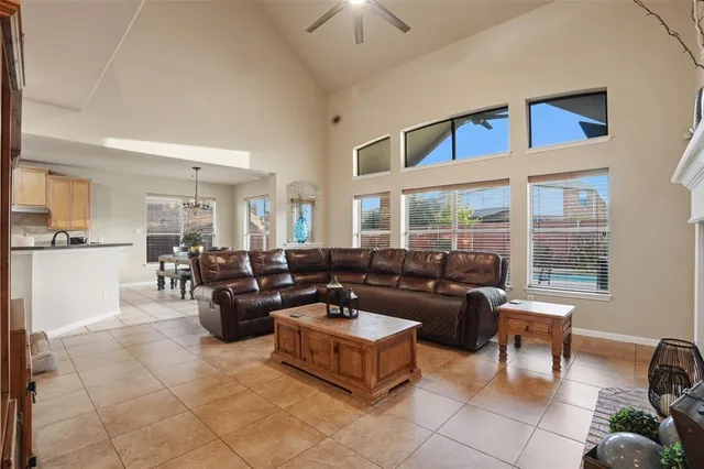 a living room with fireplace furniture and a large window