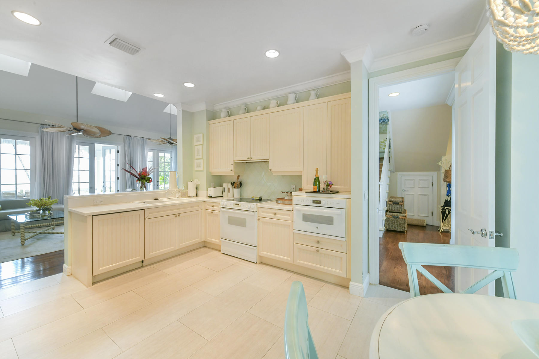 5 Sunset Key Drive Key West, FL 33040 - Photo 15 of 37 a large white kitchen with a white countertops a stove a dining table and chairs