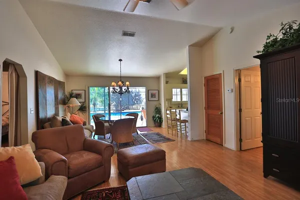 a bedroom with a bed and a dresser with the potted plants