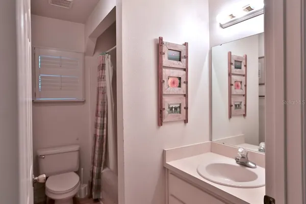 a bedroom with bed and a window