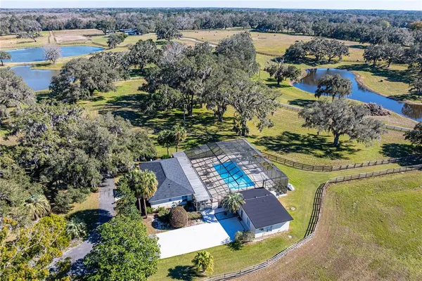 an aerial view of a house with a lake view