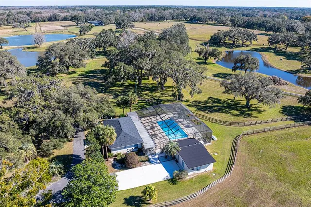 an aerial view of a house with a lake view