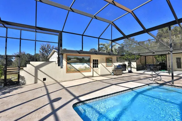 a view of a swimming pool with an outdoor space and seating area