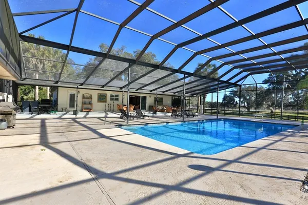 a front view of a house with a yard and a garden