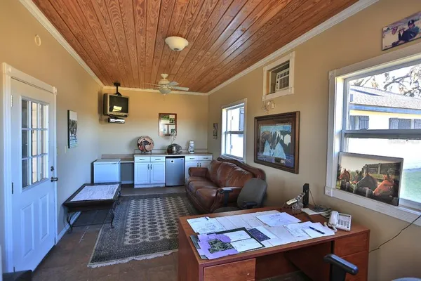 a view of a house with a yard and lake view