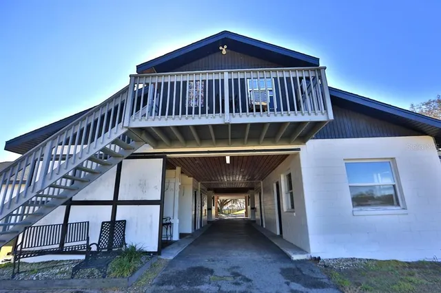 a view of a house with a yard and sitting area