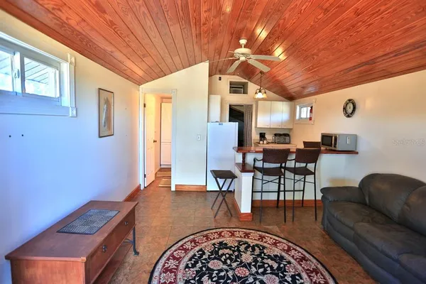a aerial view of a house with swimming pool and large trees