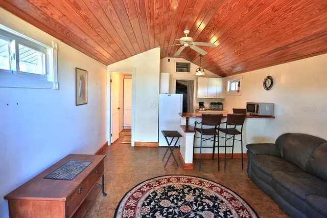 a aerial view of a house with swimming pool and large trees