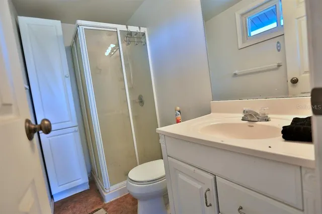an aerial view of a house with a swimming pool and outdoor seating