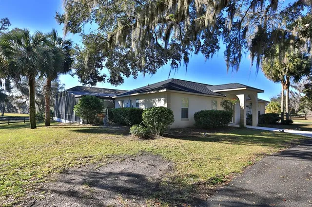 a living room with furniture a chandelier and a window