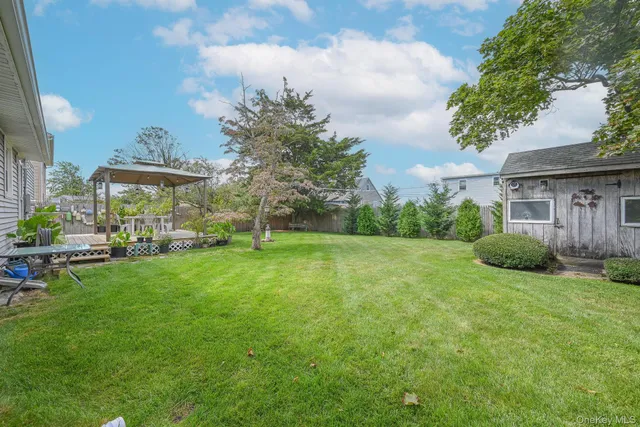 a view of a house with a big yard and potted plants