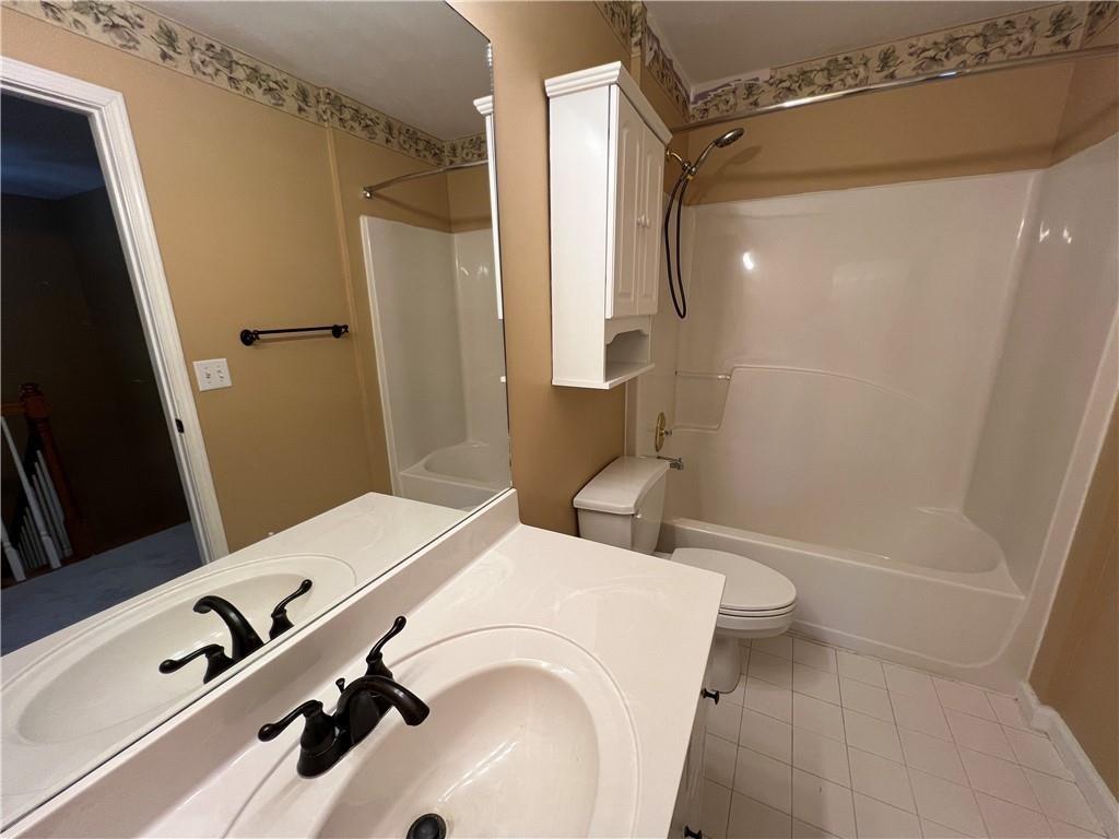 2550 Wellsley Lane Cumming, GA 30041 - Photo 14 of 22 a bathroom with a sink a toilet a mirror and shower