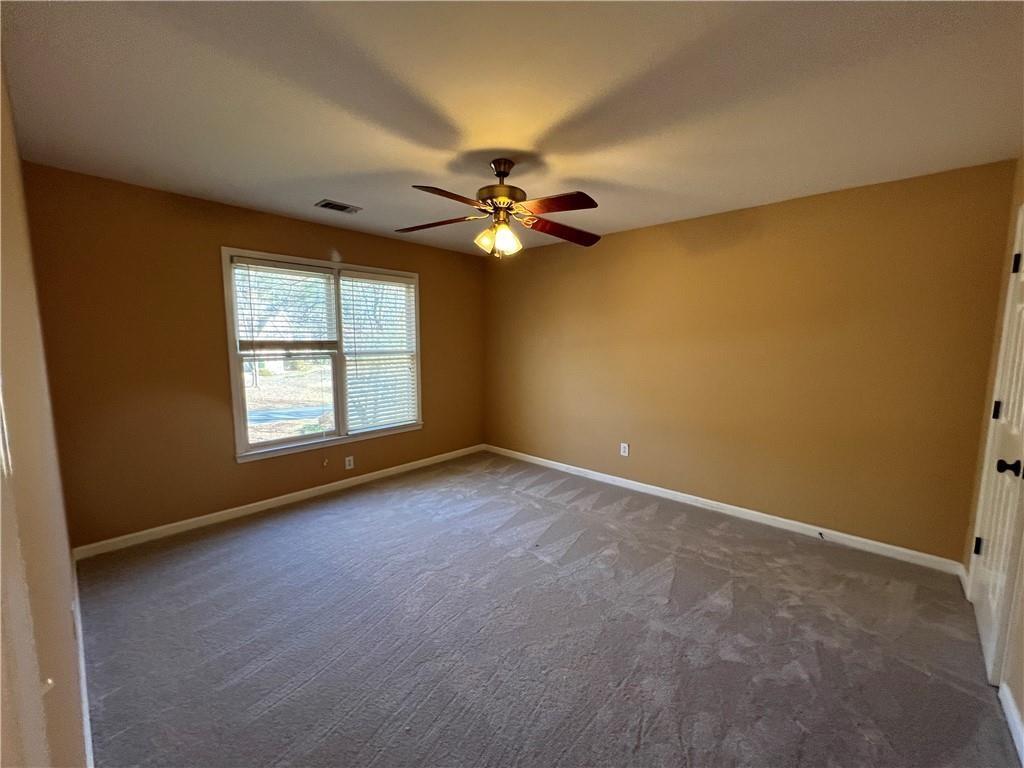 2550 Wellsley Lane Cumming, GA 30041 - Photo 16 of 22 an empty room with windows and ceiling fan