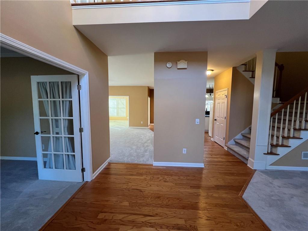 2550 Wellsley Lane Cumming, GA 30041 - Photo 2 of 22 a view of entryway with wooden floor and stairs
