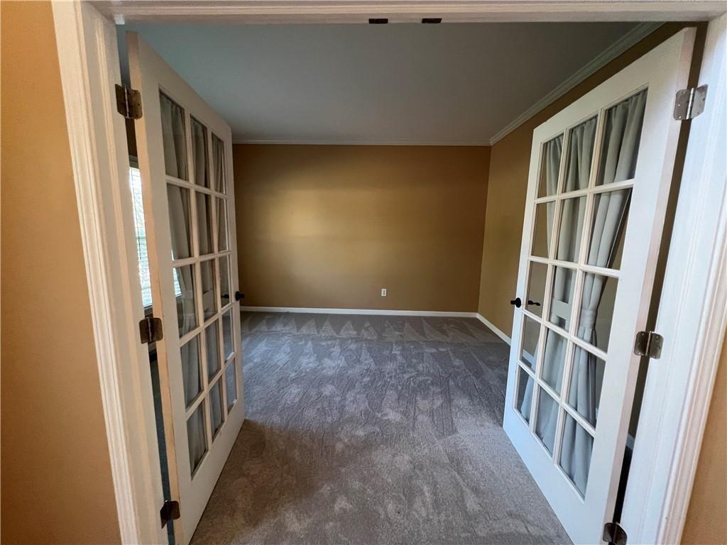 2550 Wellsley Lane Cumming, GA 30041 - Photo 3 of 22 a view of an empty room with stairs and a window