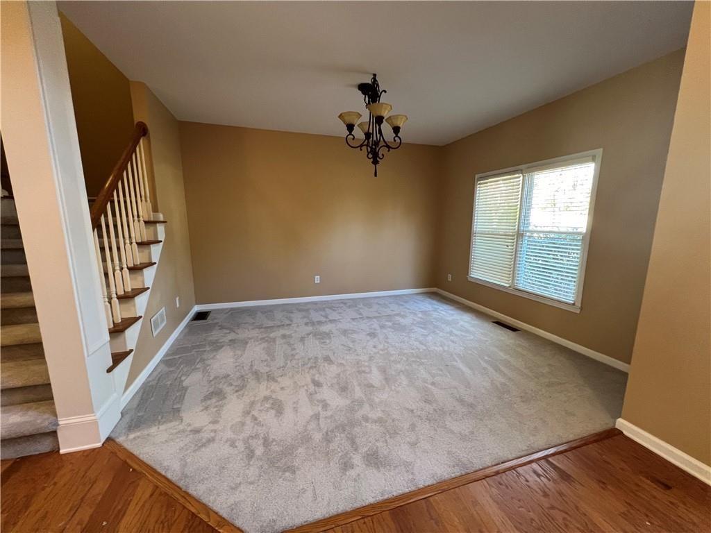 2550 Wellsley Lane Cumming, GA 30041 - Photo 4 of 22 wooden floor in an empty room with a window