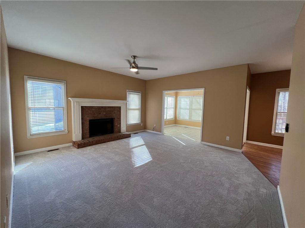 2550 Wellsley Lane Cumming, GA 30041 - Photo 5 of 22 a view of an empty room with a fireplace and a window