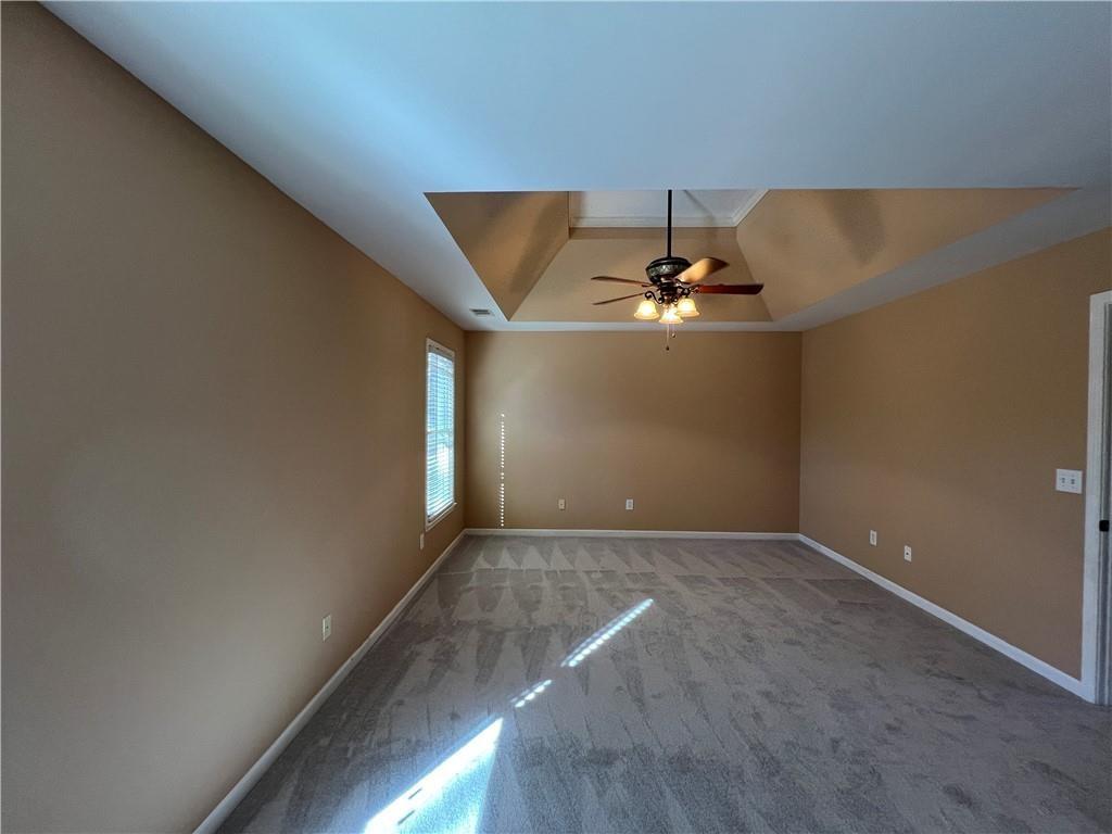 2550 Wellsley Lane Cumming, GA 30041 - Photo 10 of 22 an empty room with a ceiling fan and window