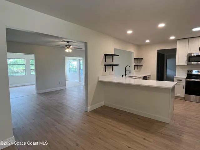 a kitchen with stainless steel appliances a refrigerator sink and cabinets