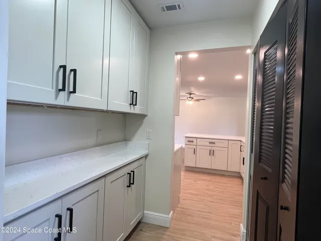a view of cabinets and wooden floor