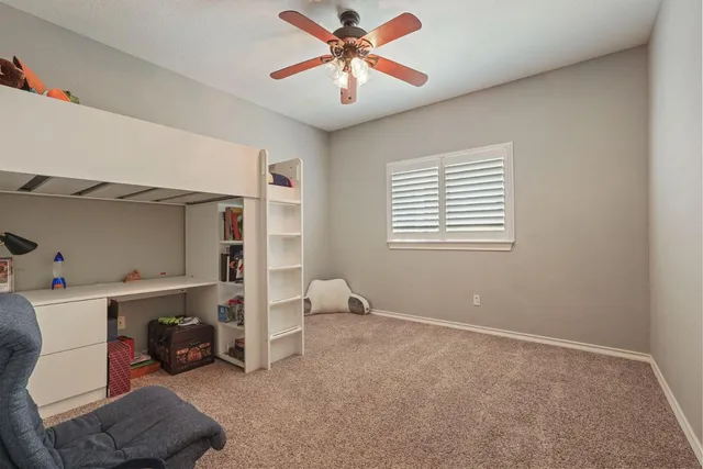 wooden floor & ceiling fan in a room