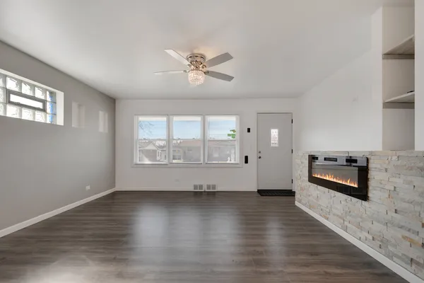 a living room with furniture wooden floor and a window