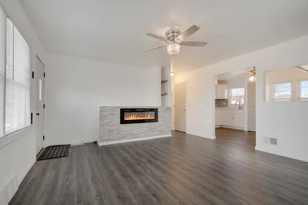 a view of an empty room and wooden floor