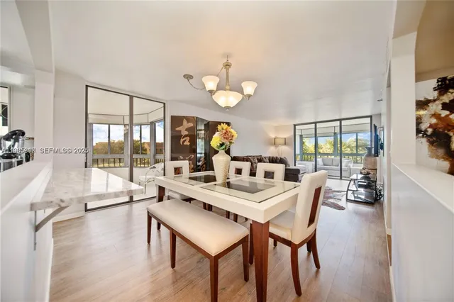 a view of a dining room with furniture wooden floor and chandelier