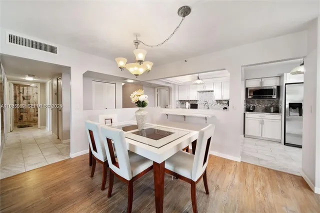 a kitchen with a table and chairs in it