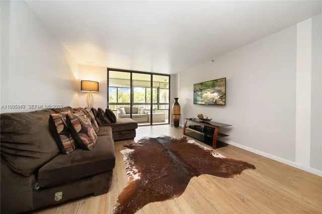 a bedroom with a bed a couch and a window