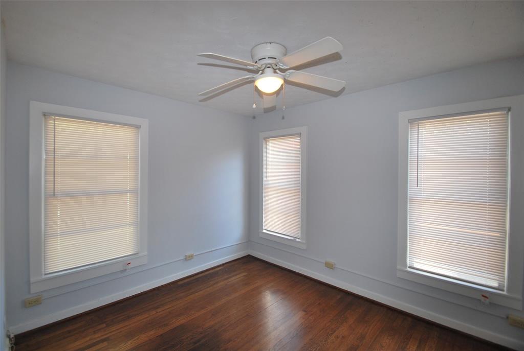 6918 Lockheed Avenue Dallas, TX 75209 - Photo 7 of 8 an empty room with wooden floor windows and fan