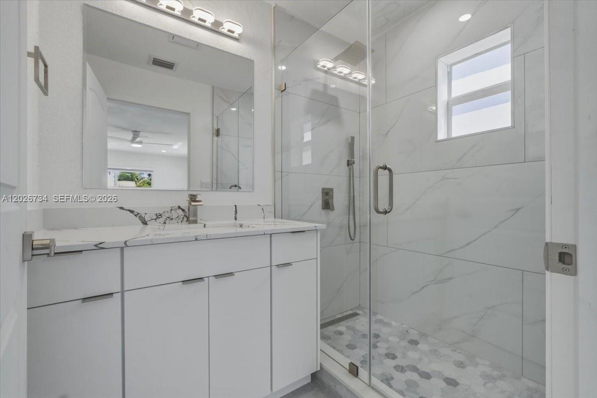 266 Southwest 6th Street Dania Beach, FL 33004 - Photo 14 of 37 a bathroom with a shower sink and mirror
