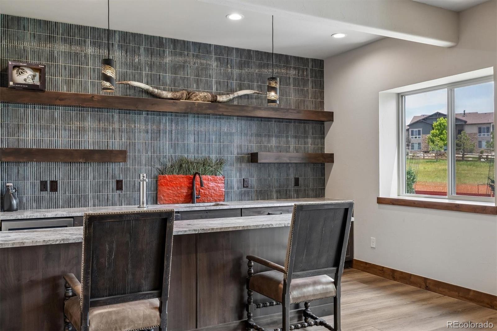 5754 Powell Road Parker, CO 80134 - Photo 31 of 43 a kitchen with a wooden table and chairs