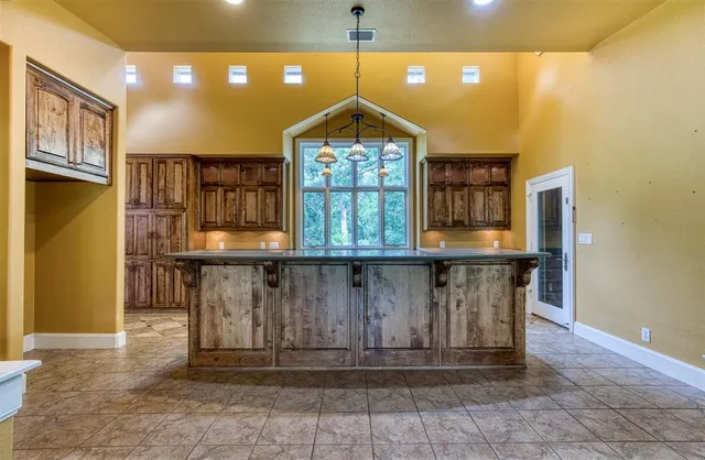 a kitchen with granite countertop a stove a sink and a microwave