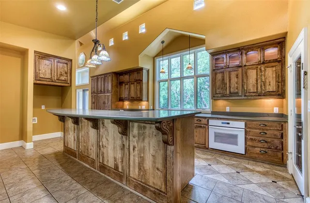 a kitchen with stainless steel appliances granite countertop a stove and cabinets