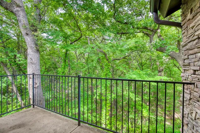 a balcony with trees in front of it