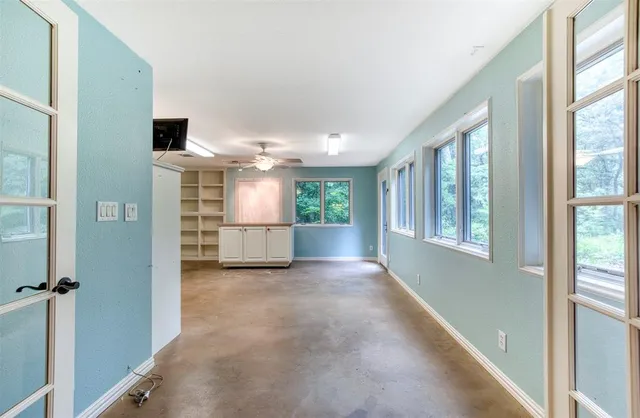 a large white kitchen with granite countertop a stove